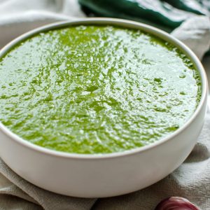 Side overhead view of a bowl full of poblano enchilada sauce.