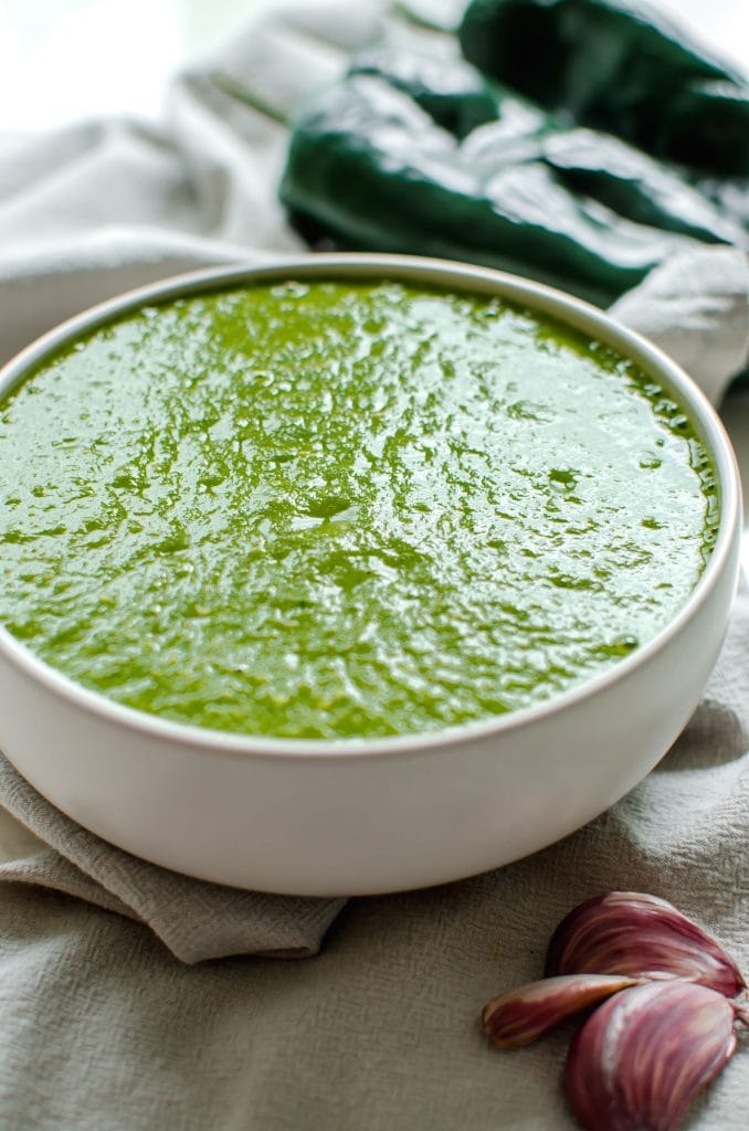 Side overhead view of a bowl full of poblano enchilada sauce.