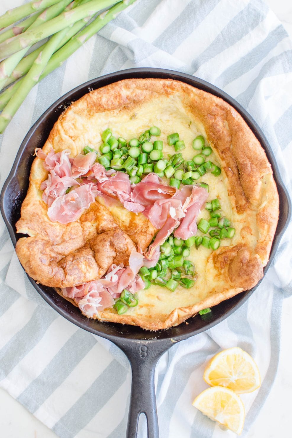 This recipe for a savory Dutch Baby is loaded with fresh springtime flavor and features a nutty Raspberry cheese, tender bites of fresh Asparagus, and salty shaved Serrano ham. 