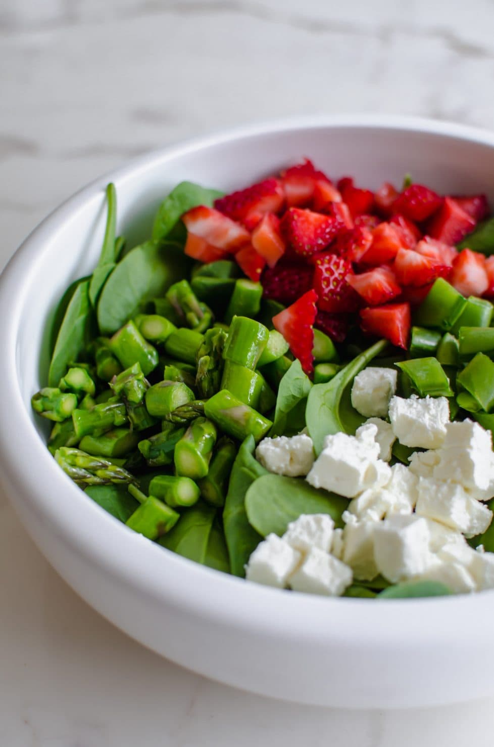 A white bowl with salad.