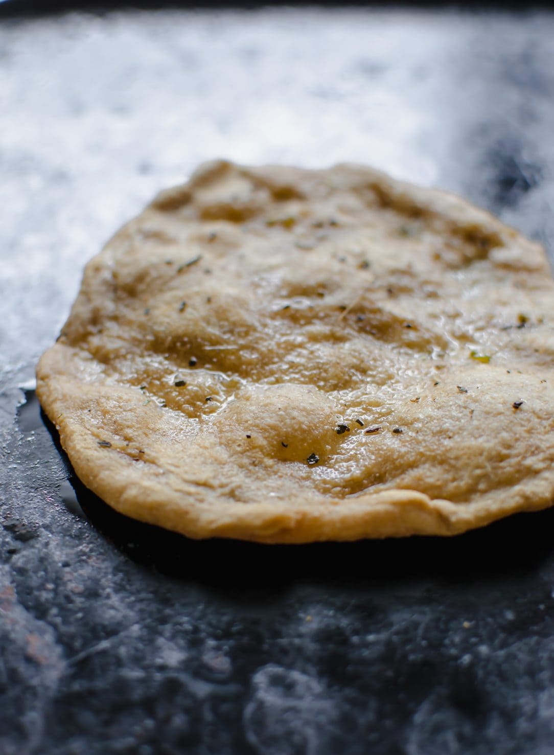 A pita being warmed in a pan. 