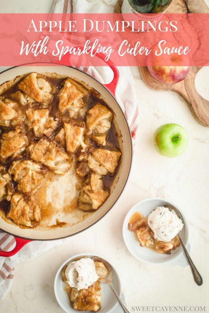 An overhead shot of apple dumplings in a red cast iron braised on a white counter top.