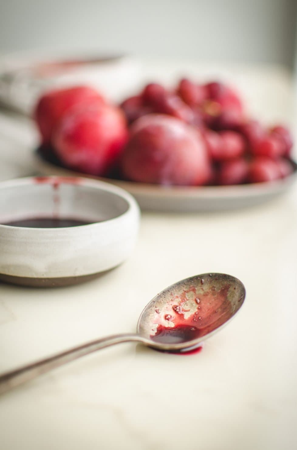 Pomegranate syrup on a spoon.