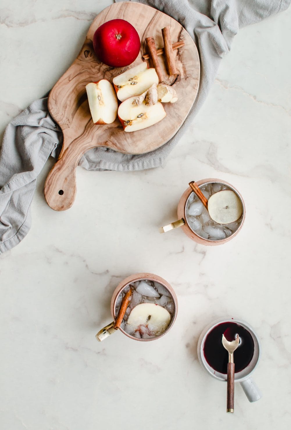 An overhead shot of moscow mule mugs filled with Applepom Fizz mocktail.