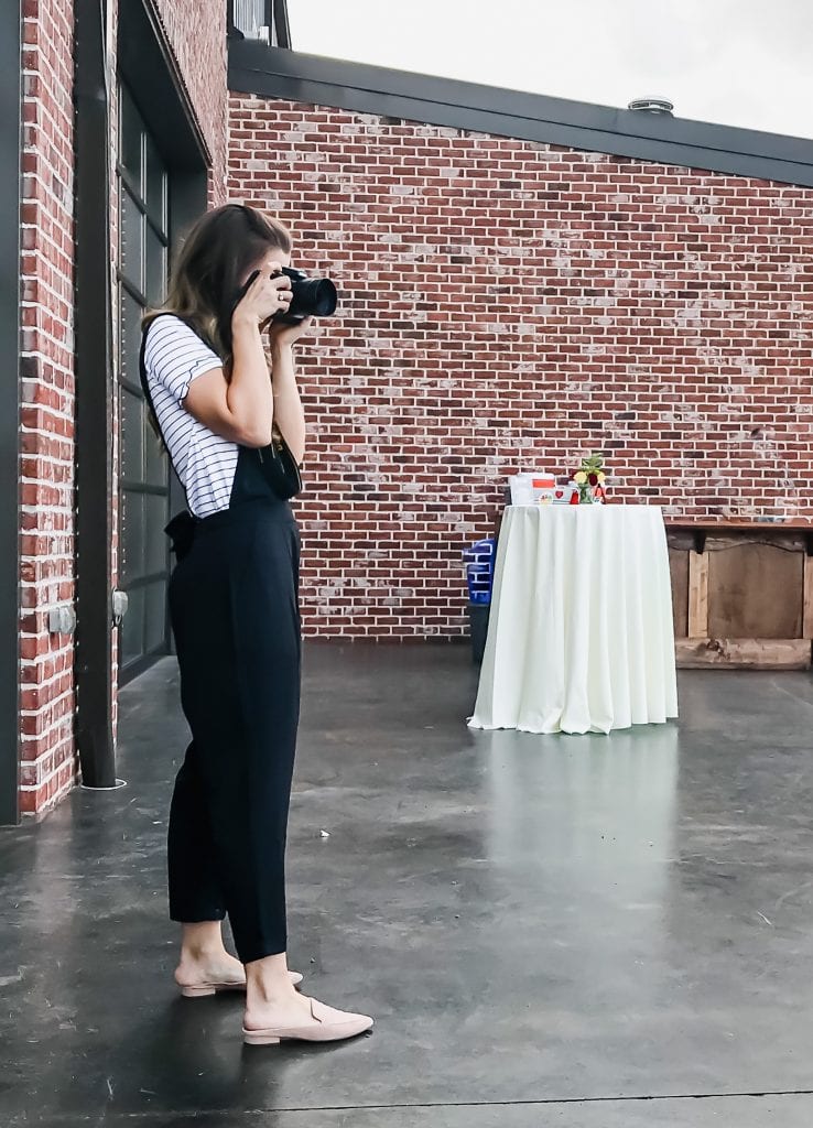 Whitney Reist shooting photos at a an outdoor food event. 