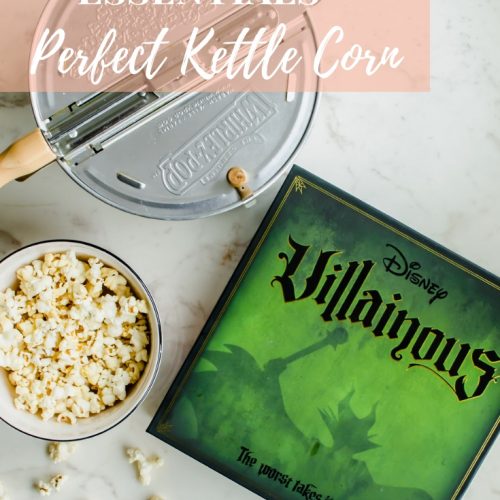 The Disney Villainous game next to a Whirly Pop and bowl of popcorn.