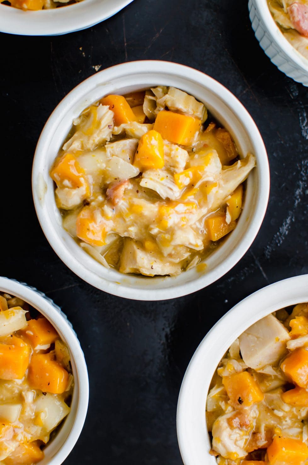 A white ramekin filled with turkey pot pie filling.