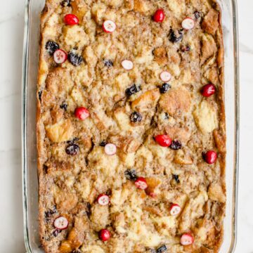 An overhead shot of a glass casserole dish with a baked bread pudding.