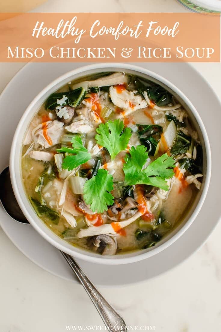 A white bowl filled with miso chicken and rice soup that is garnished with sriracha sauce and a cilantro sprig.