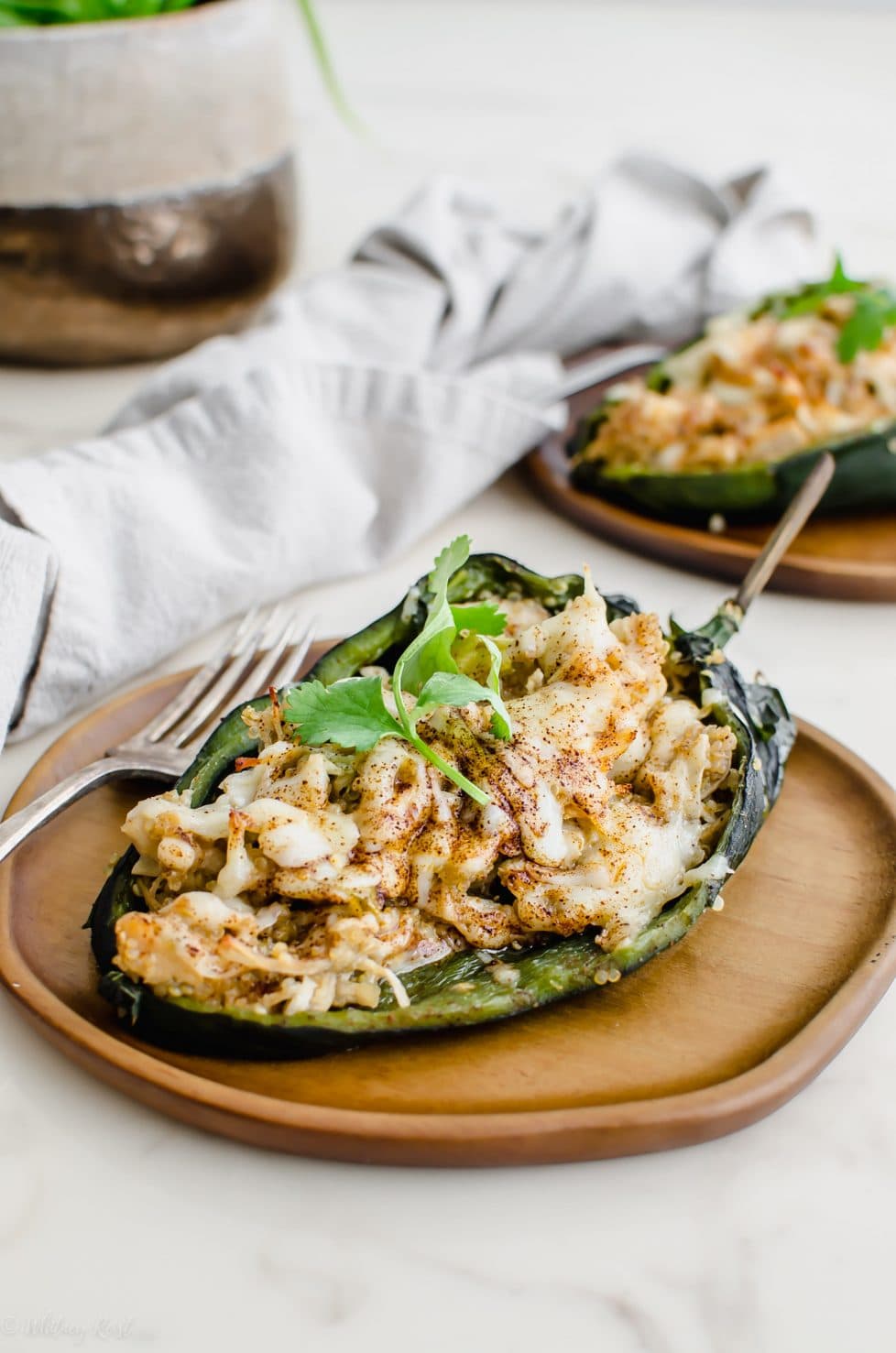 Wooden plates with stuffed poblano peppers. 