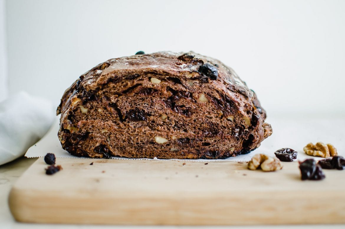 An up close of sliced chocolate cherry walnut bread.