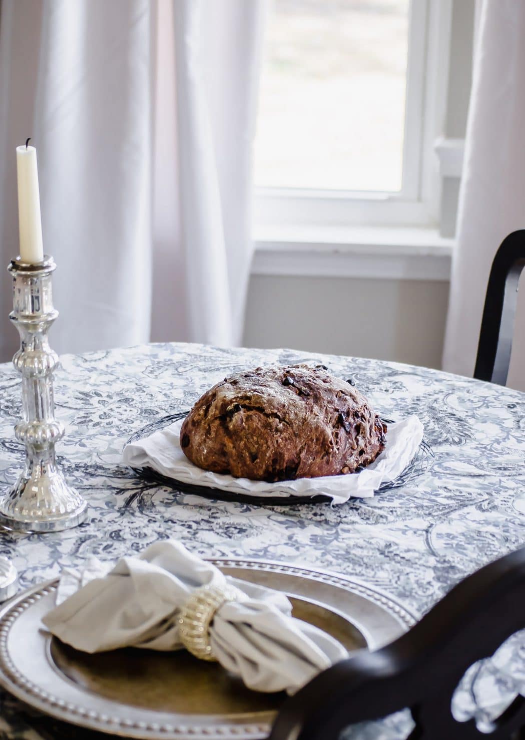 A loaf of chocolate rye bread on a table.