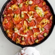 A cast iron skillet filled with pizza baked gnocchi.