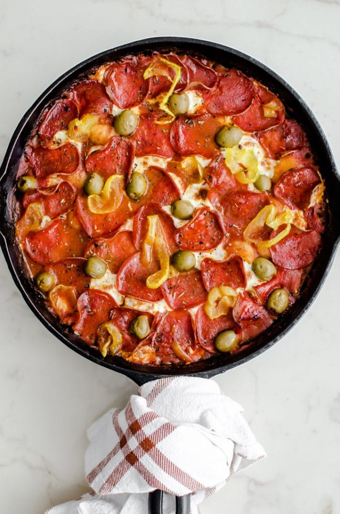 A cast iron skillet filled with pizza baked gnocchi. 