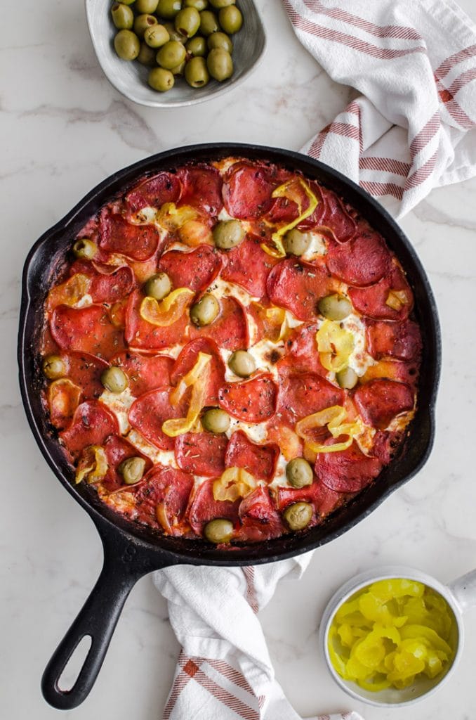 A cast iron skillet filled with pizza baked gnocchi.