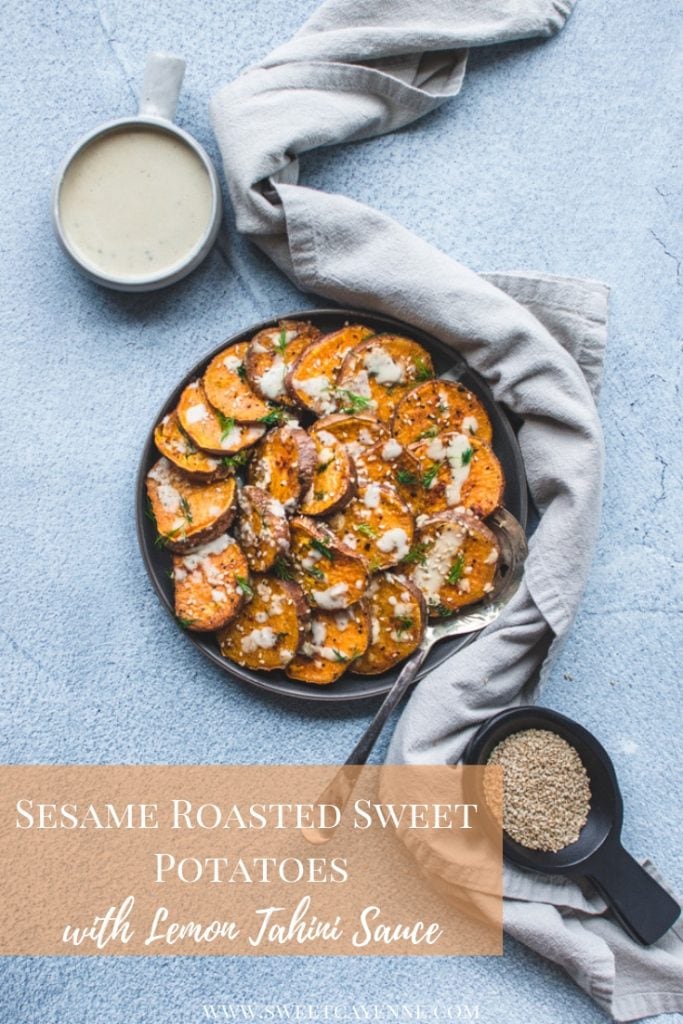 A grey plate with roasted sesame sweet potatoes on a blue concrete backdrop.