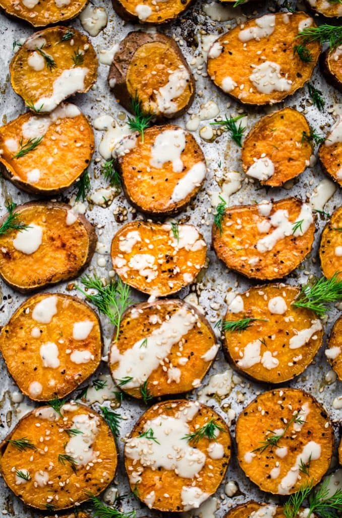 A sheet pan full of roasted sesame sweet potato rounds.