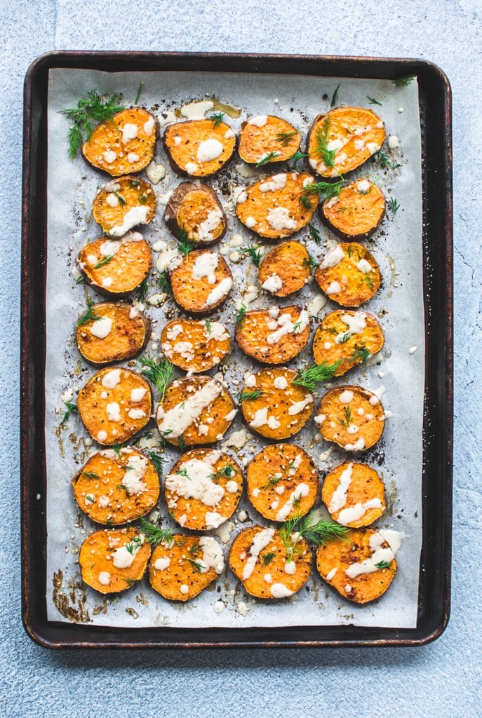 A sheet pan full of roasted sesame sweet potato rounds.