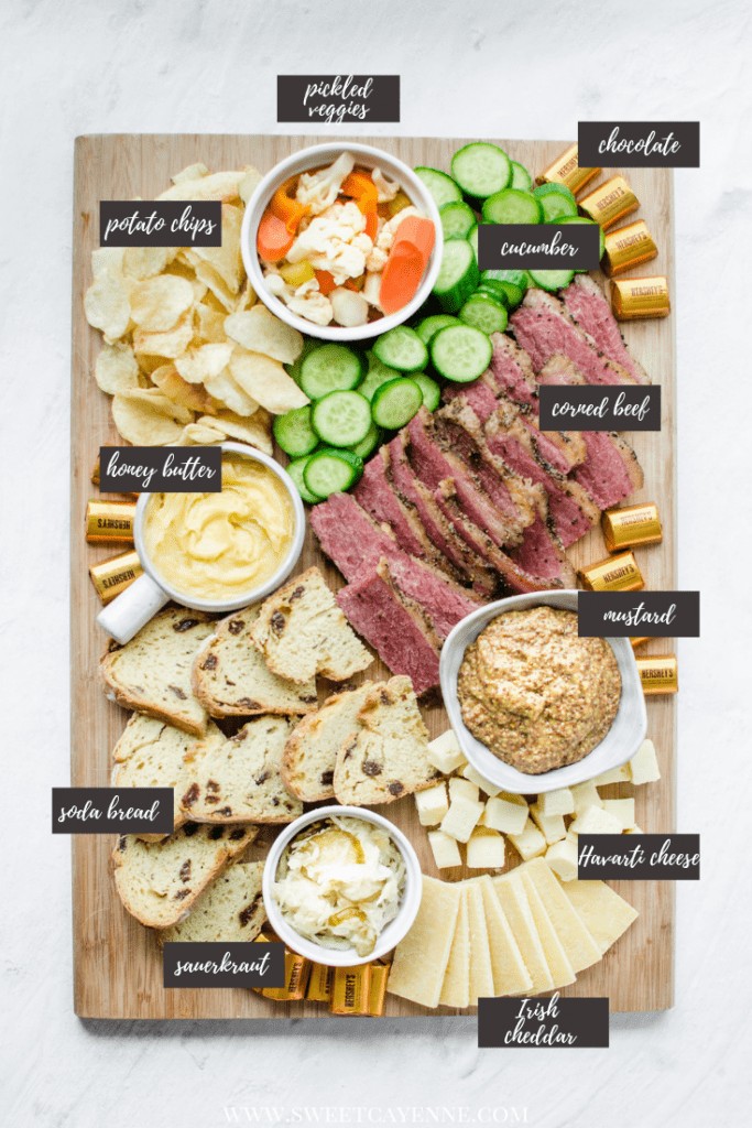 A wooden board filled with grazing platter foods for St. Patrick's Day.