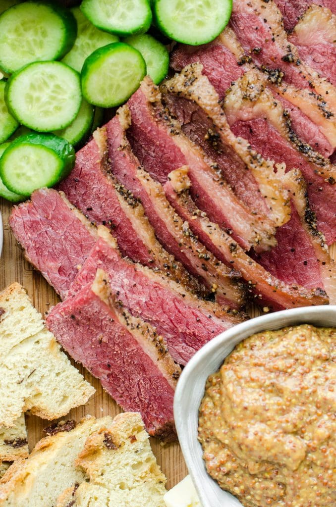 A close up of corned beef slices on a charcuterie board. 