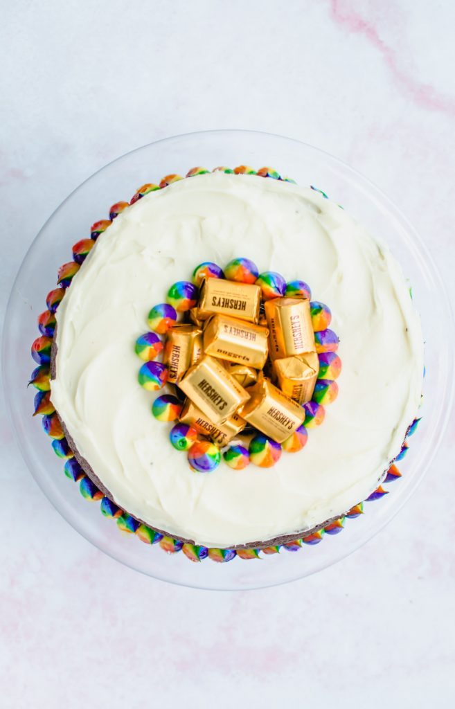 An overhead shot of a Pot O' Gold chocolate stout cake on a pink marble backdrop.