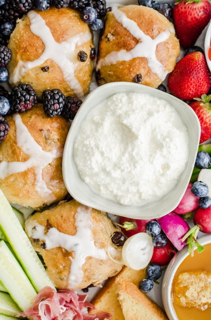 A close up shot of a bowl of fresh ricotta cheese on an Easter brunch grazing board.