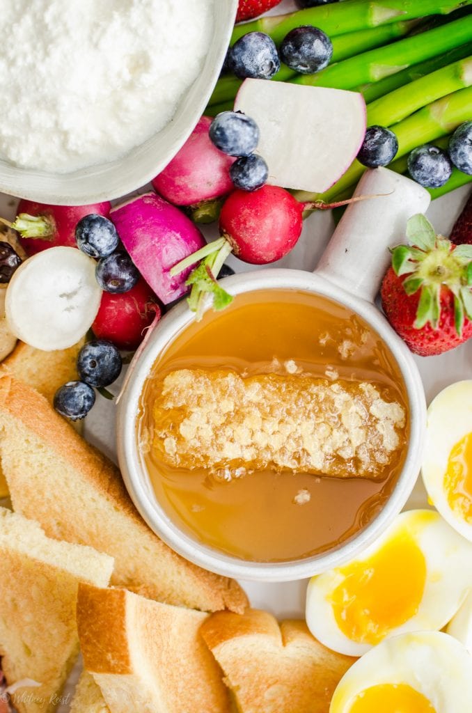 A close-up shot of a bowl of honey comb on an Easter brunch grazing board.