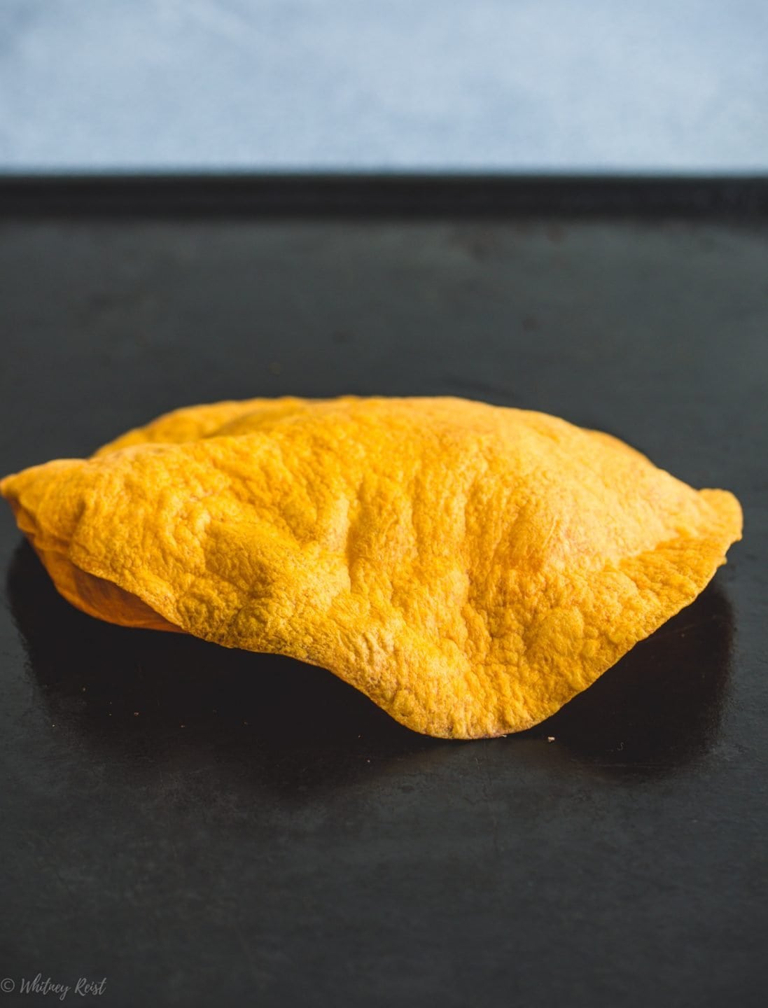 A crispy tortilla on a cooking tray.