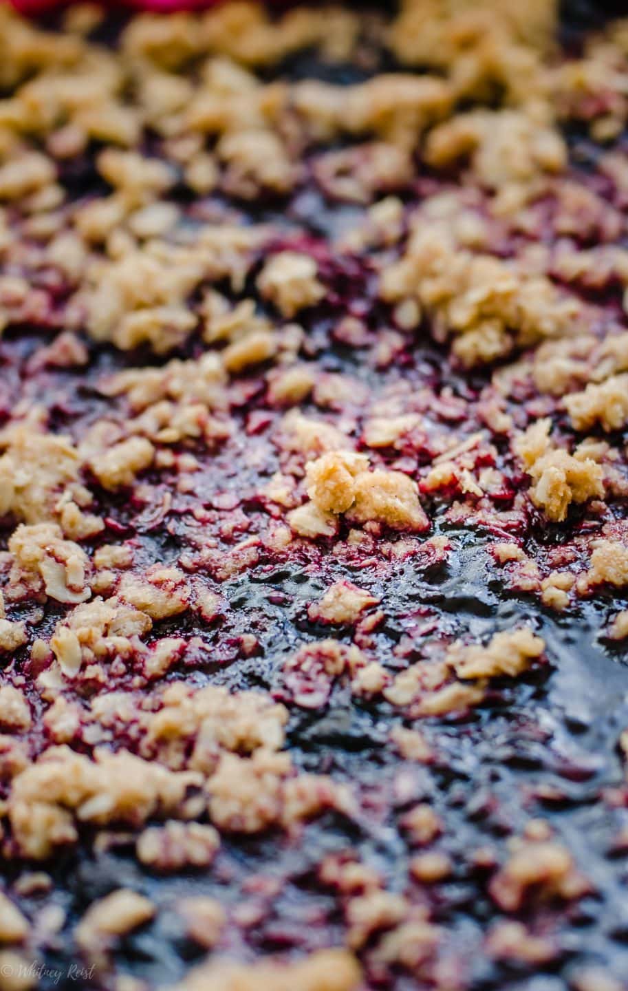 A close-up shot of the crumble on a berry crisp to show the texture.