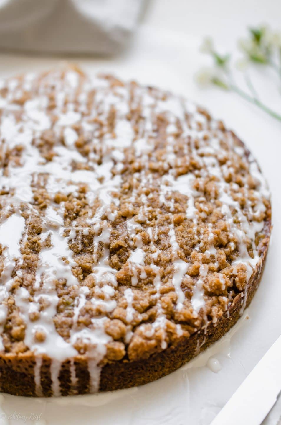 A side view of a zucchini coffee cake on a cutting board.