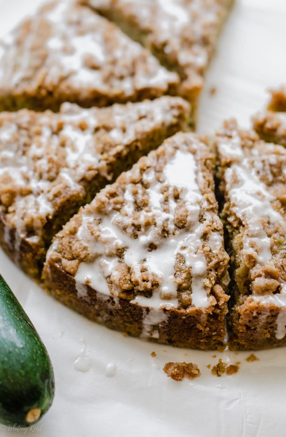 A close up shot of a sliced zucchini coffee cake to show the texture of the crumb topping.