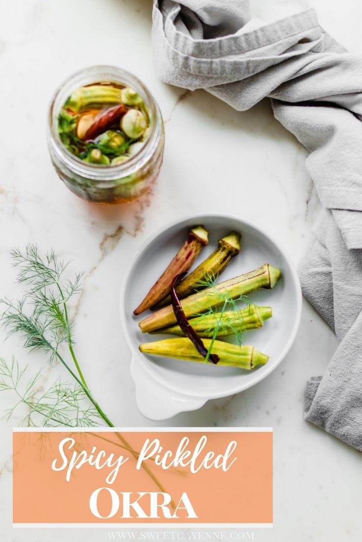 An overhead shot of a white dish with pickled okra and a jar of pickled okra on the side.