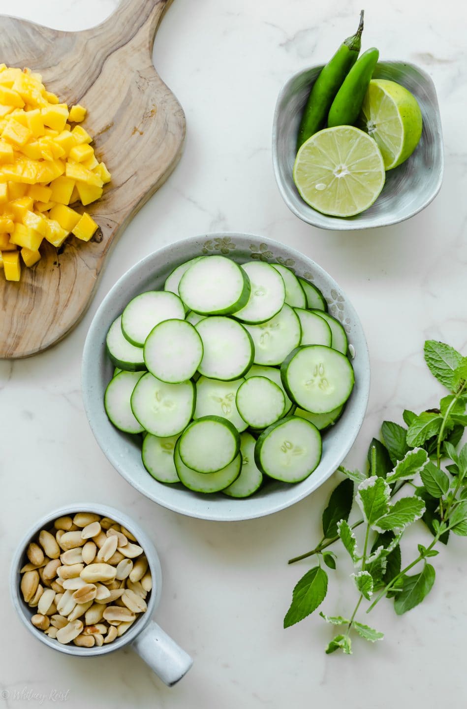 A bowl of fresh sliced cucumber prepped for making Thai cucumber mango salad.