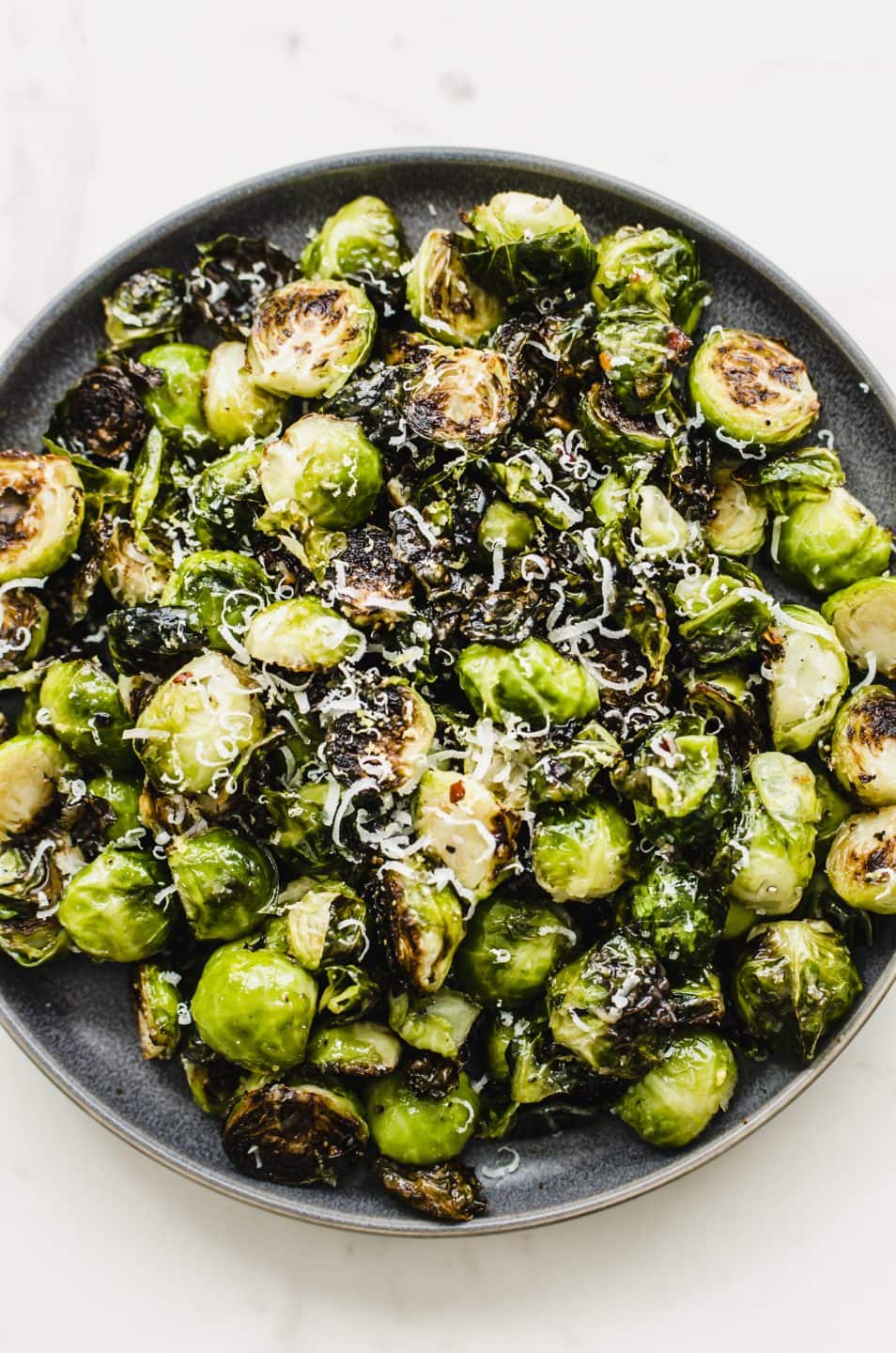 An overhead shot of a plate of crispy roasted Brussels sprouts.