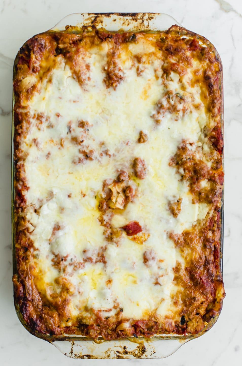 An overhead shot of a glass baking dish filled with baked Turkey Florentine Lasagna.