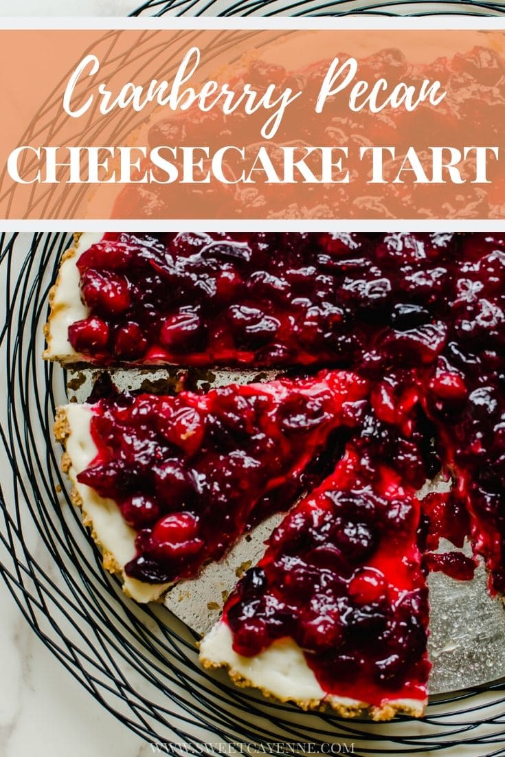 A close-up shot of a cranberry cheesecake tart with two slices being removed.