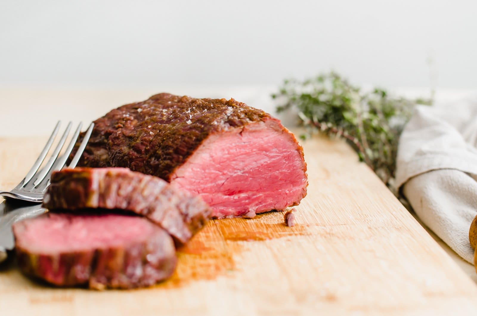 A close up shot of beef tenderloin being sliced.