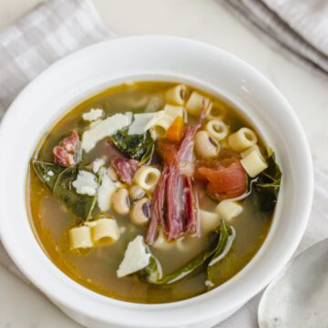 An up-close shot of a white bowl of Southern-style pasta e Fagioli.