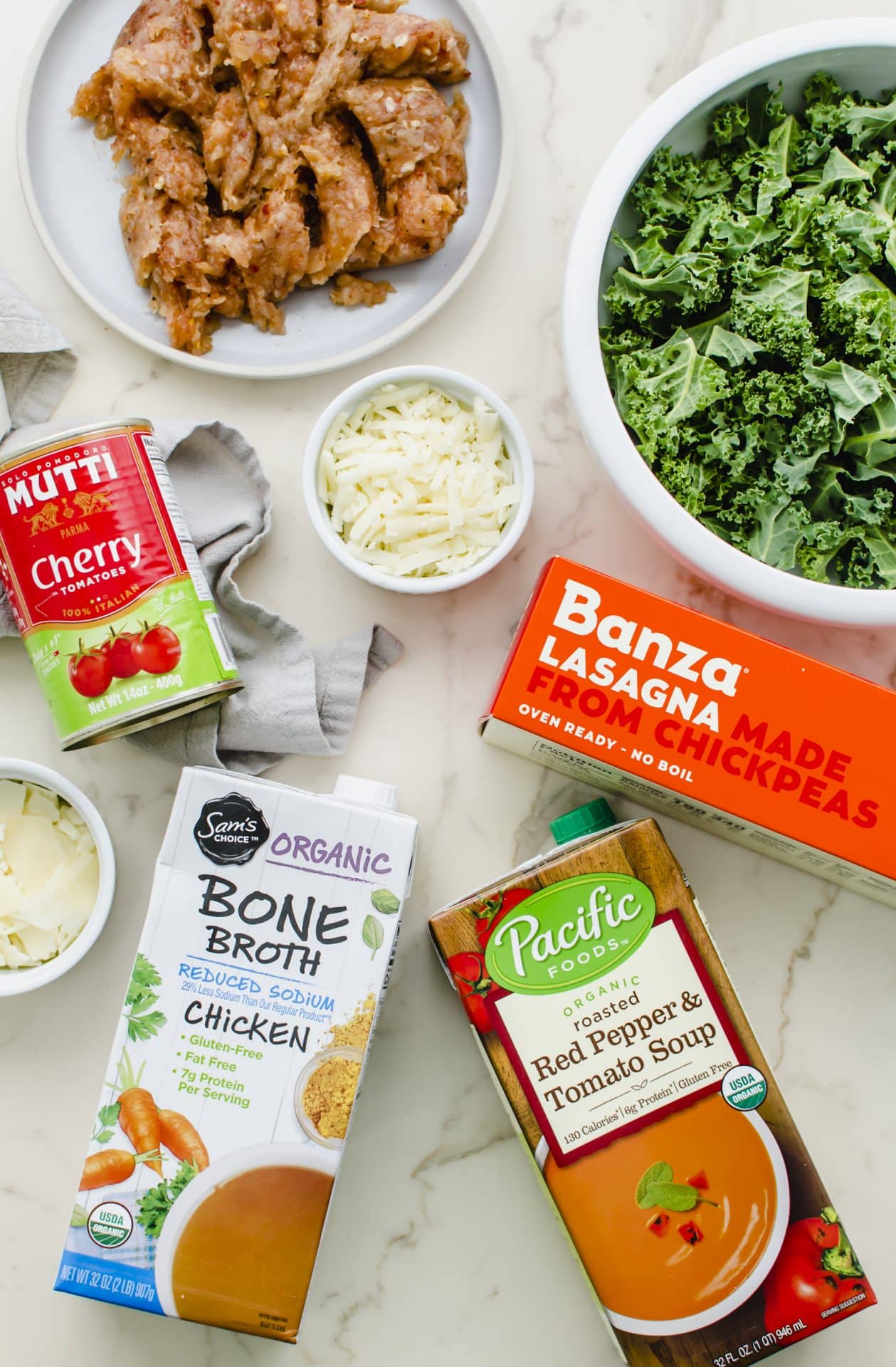 All of the ingredients prepped for making Lasagna Soup on a white counter top.