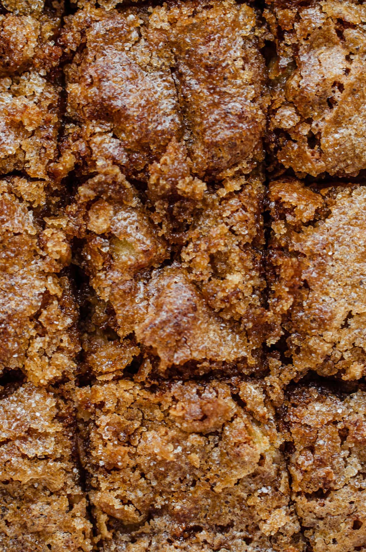 An up-close shot of the crunchy sugar topping on baked banana bread. 