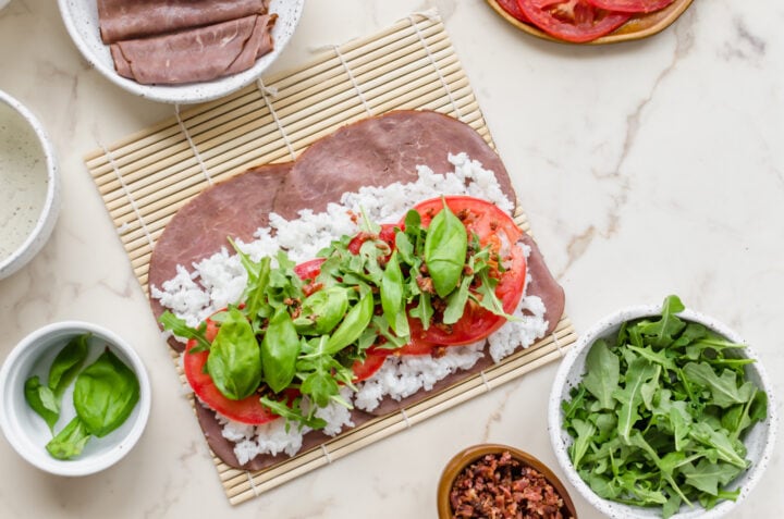 Ingredients piled on a bamboo mat for a BLT beefshi roll. 