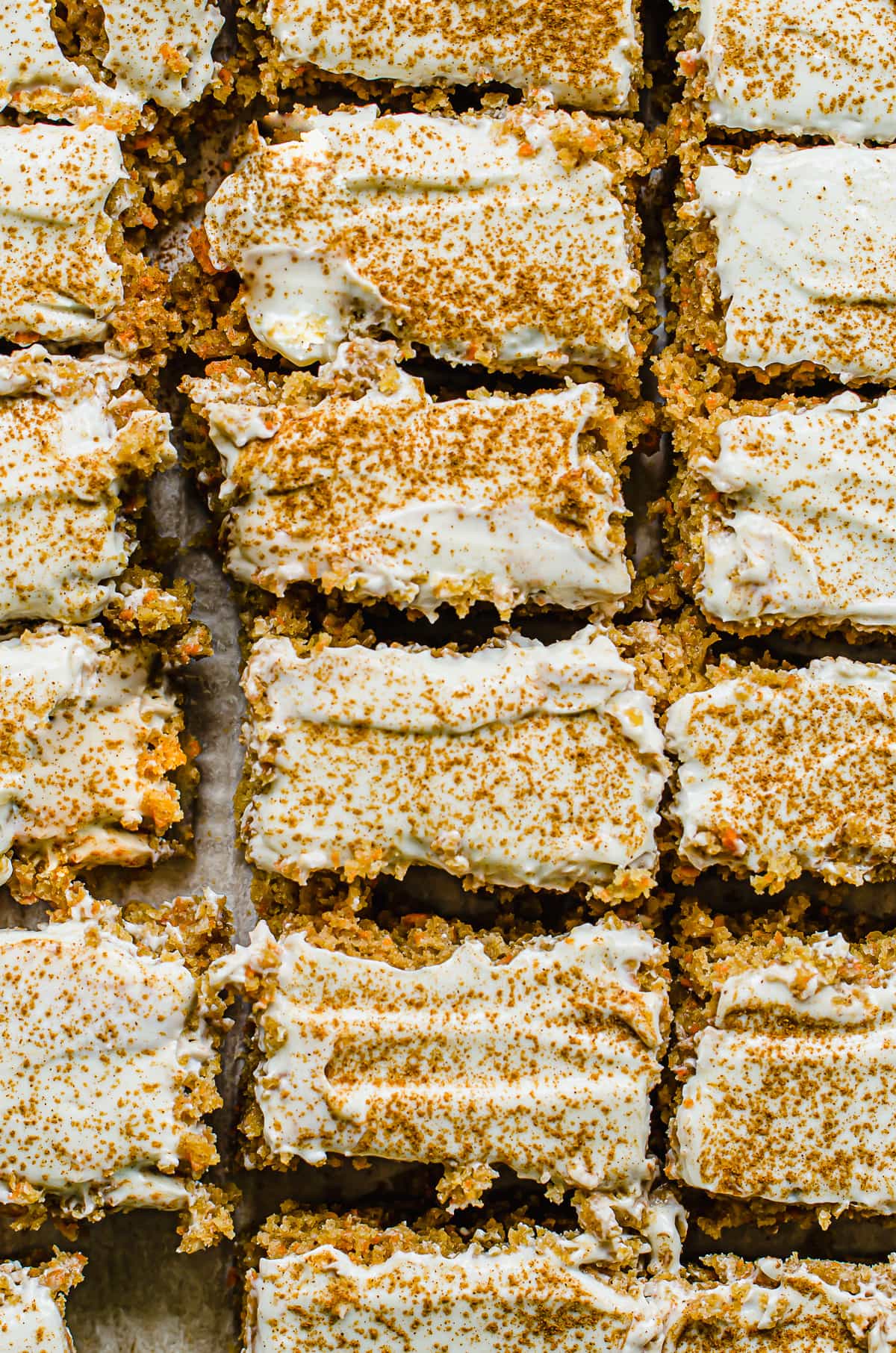 A close up shot of cake bar slices sprinkled with cinnamon.