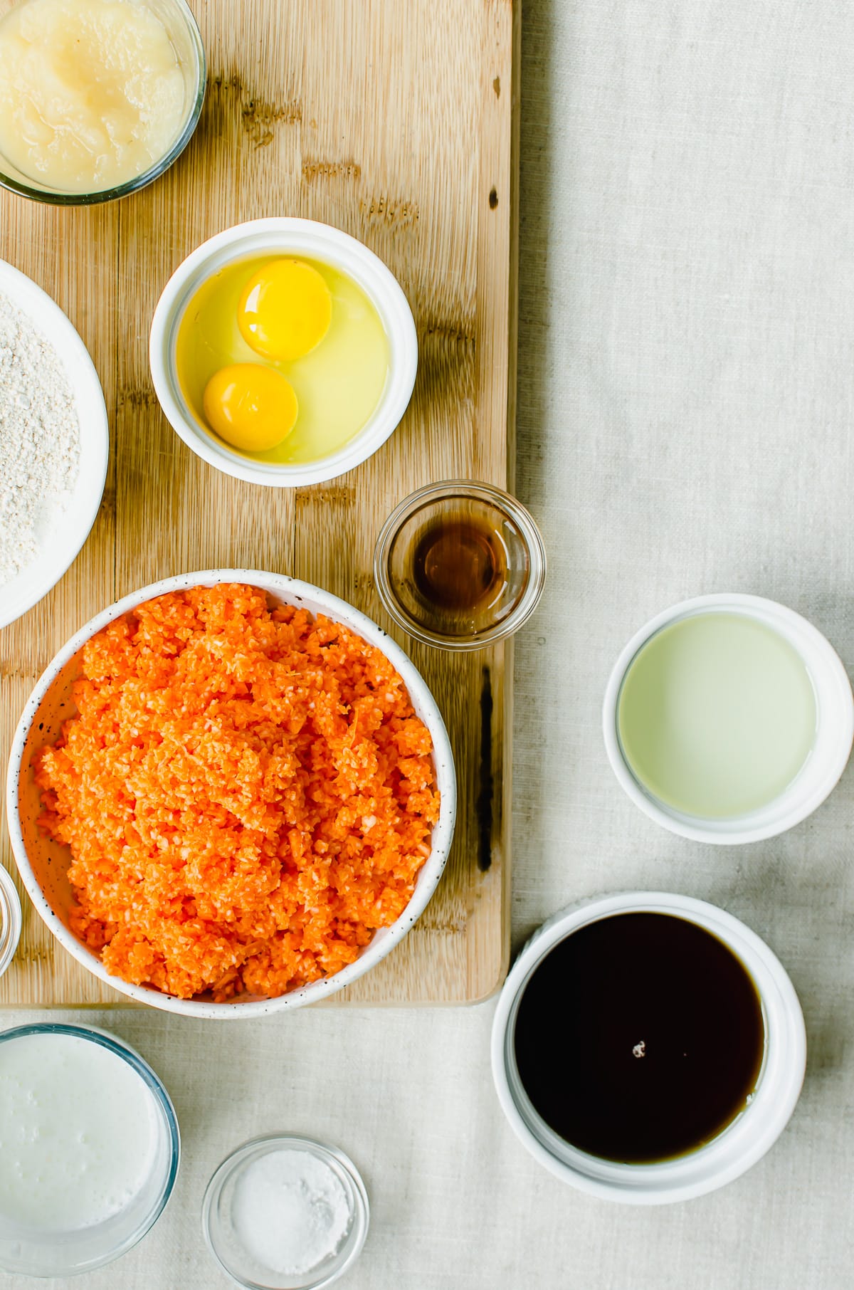 Bowls of measured ingredients for making carrot cake.