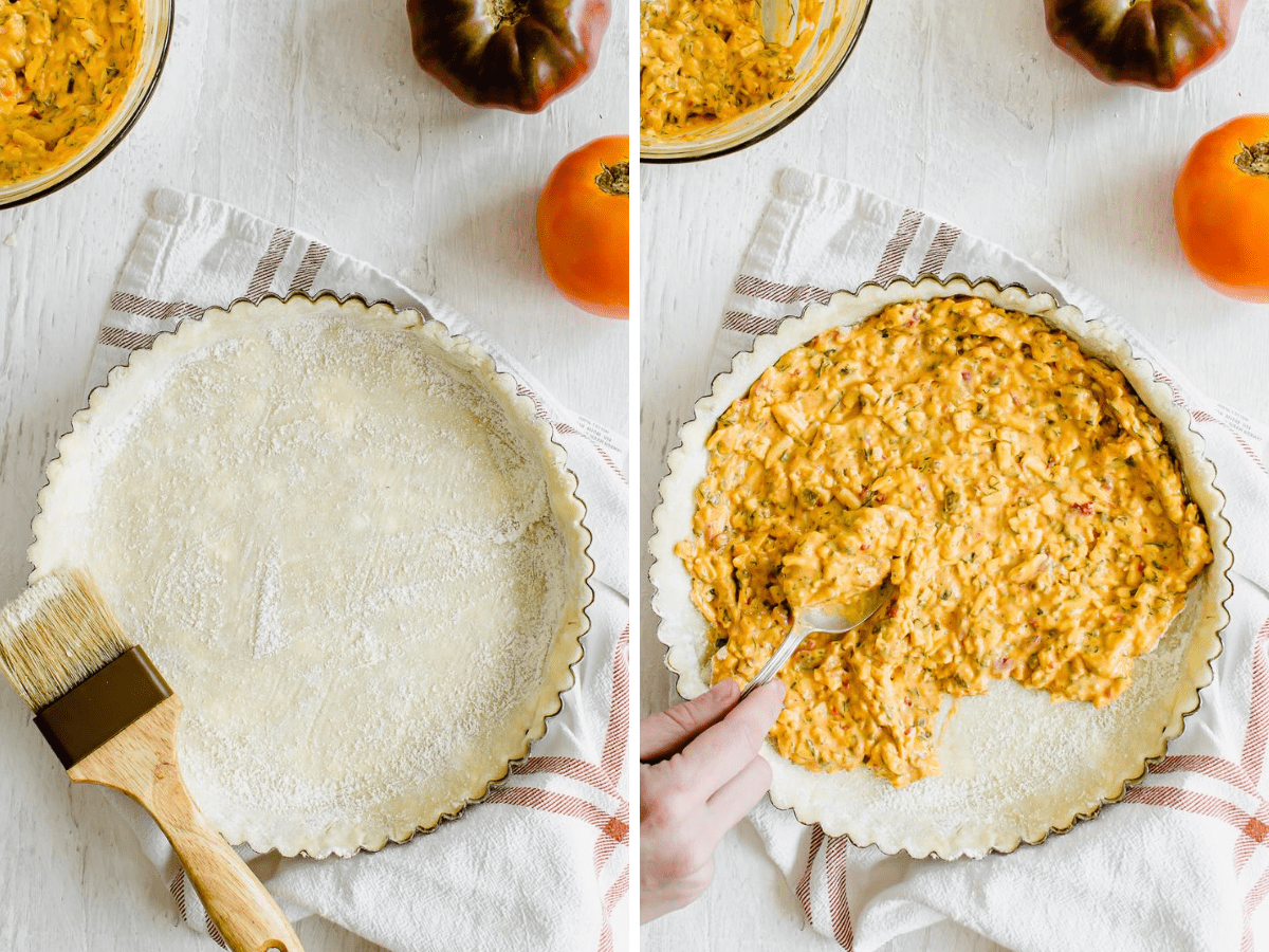 Pimento cheese filling being spread into the bottom of a tart pan filled with dough.