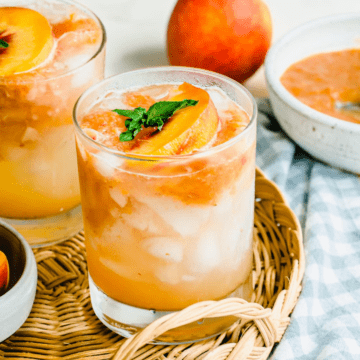 A short glass tumbler filled with peach lemonade.