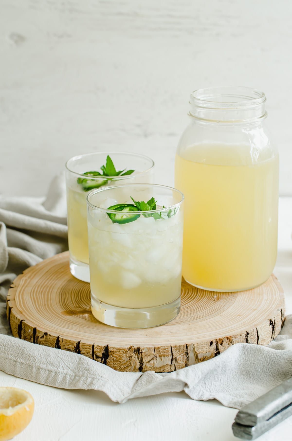 A straight-on shot of a wooden serving tray with freshly squeezed lemonade.