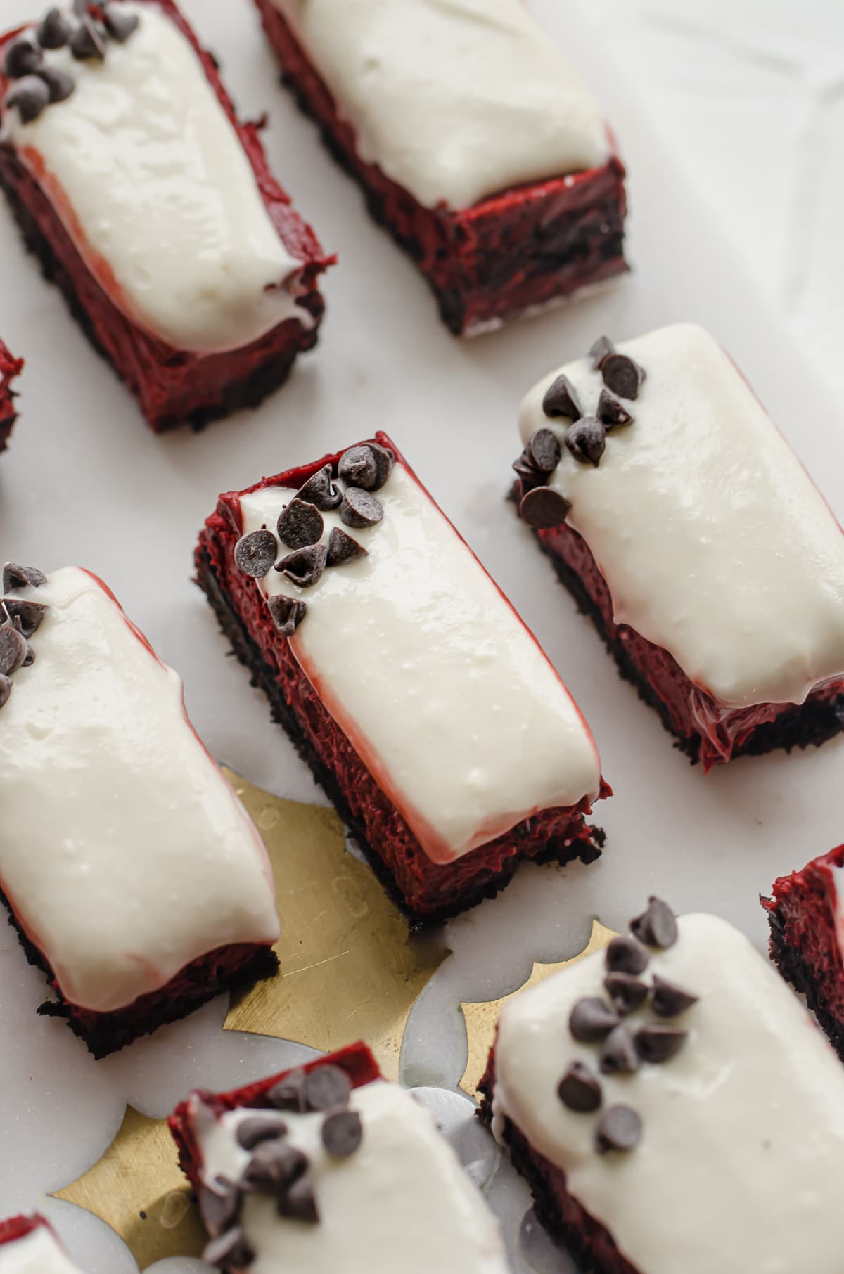 A close up shot of a red velvet cheesecake bar on a platter.