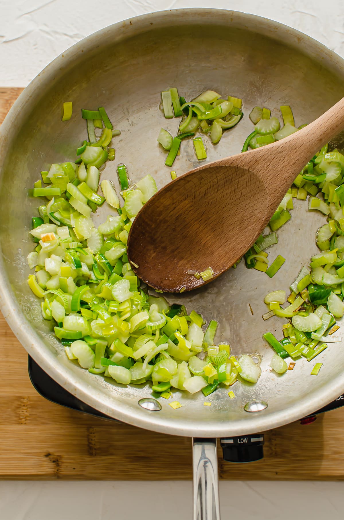 Sauteed leeks and garlic in a skillet.